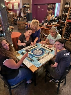 Group of women playing MahJong together at a wine bar